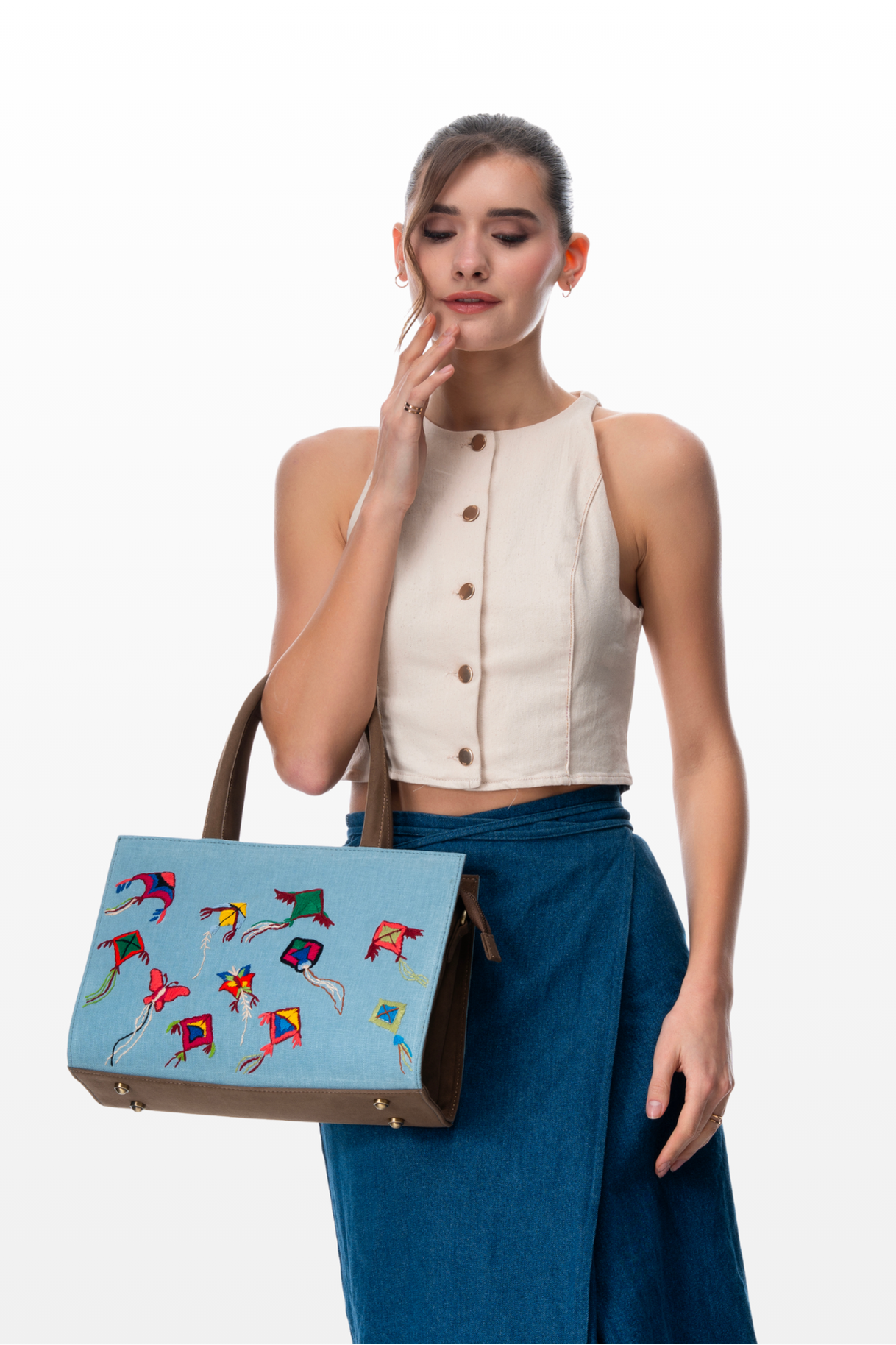 Woman carrying Celebration Kites handbag by the brand Story of Strings 