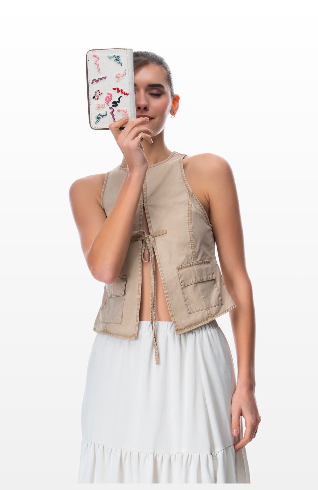 A woman holding Colourful Scales wallet by the brand Story of Strings.