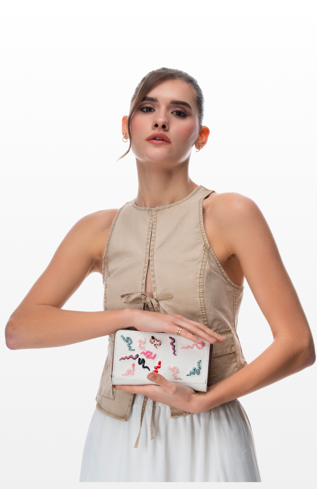 A Woman holding a Colourful Scales wallet by the brand Story of Strings.