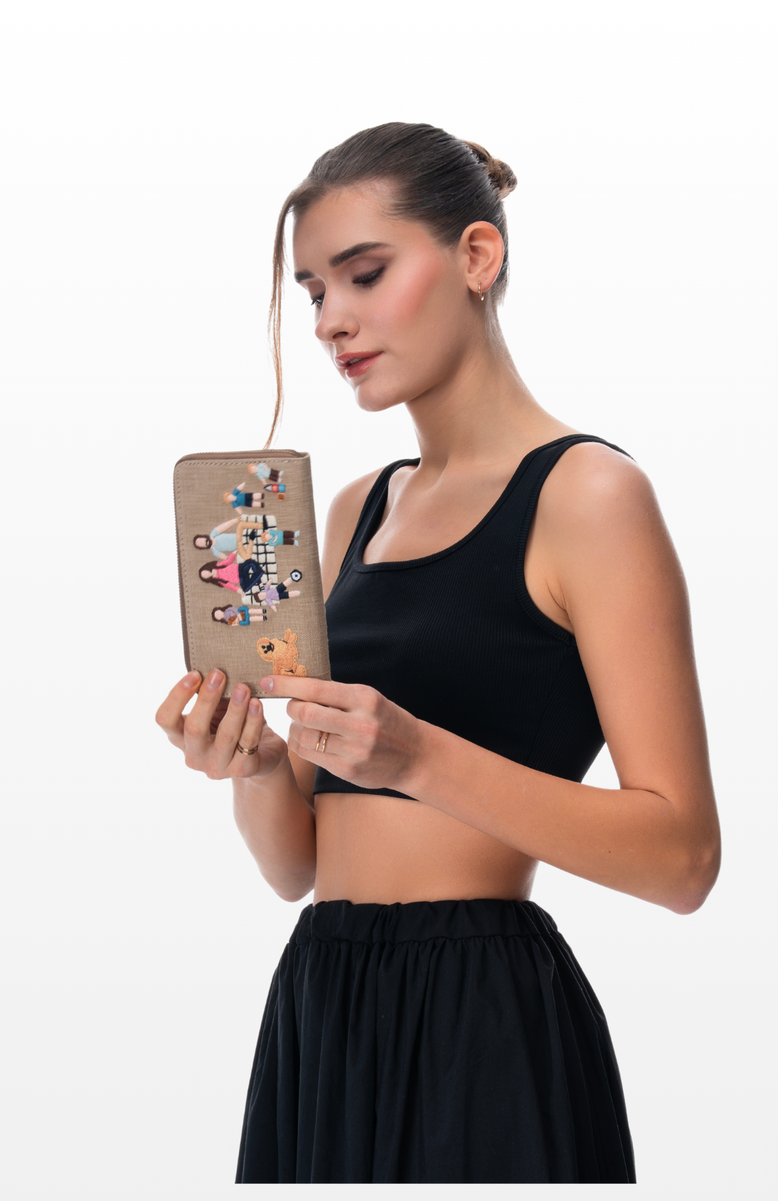 A woman holding Family Picnic wallet by the brand Story of Strings.