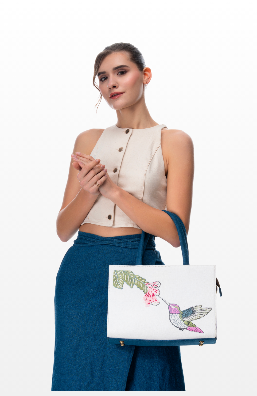 A woman wearing Feather & Bloom tote bag by the brand Story of Strings.