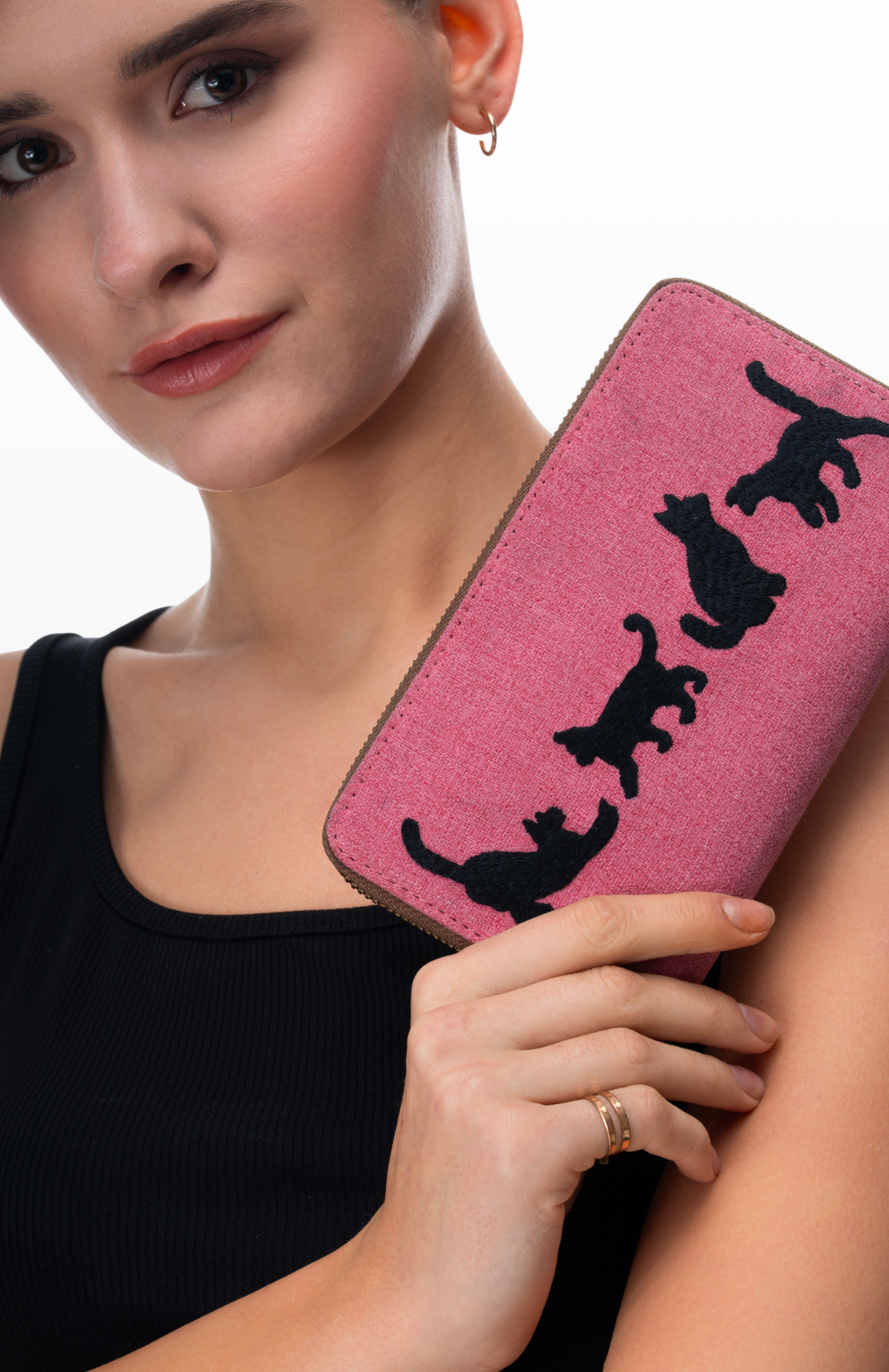 A woman holding Four the Love of Cats wallet by the brand Stroy of Strings.