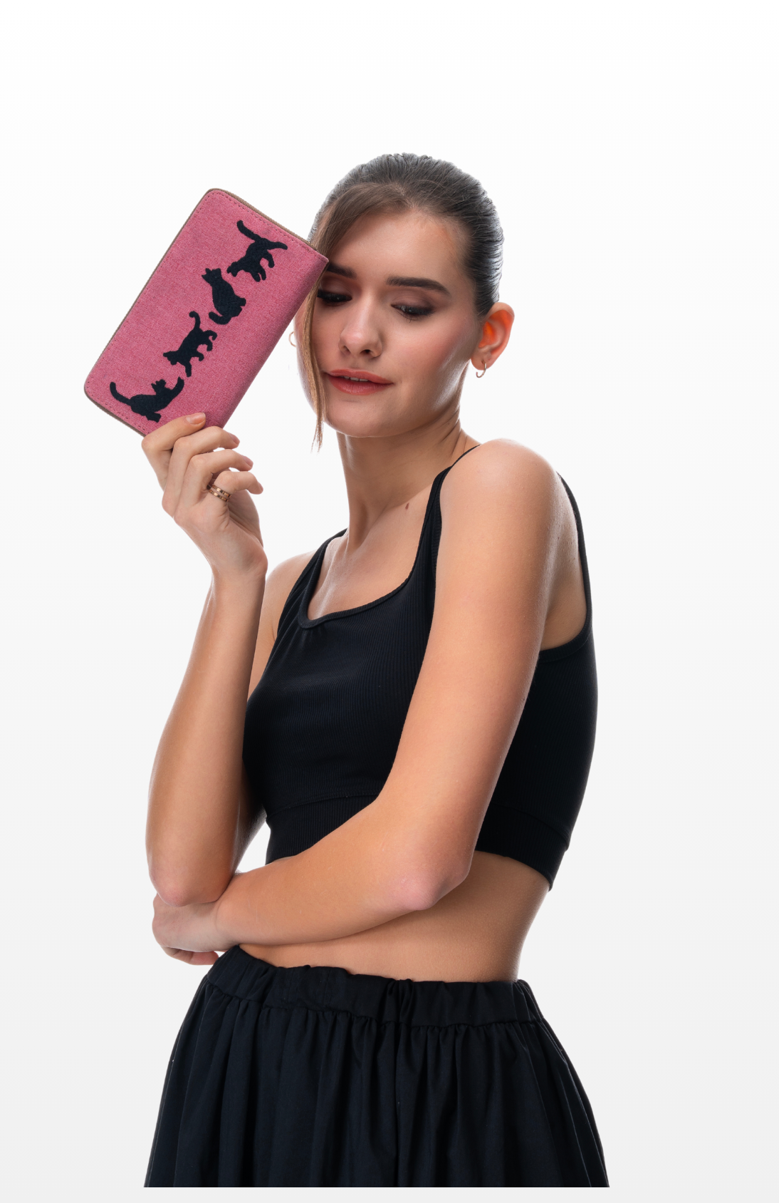 A woman holding Four the Love of Cats wallet by the brand Story of Strings.