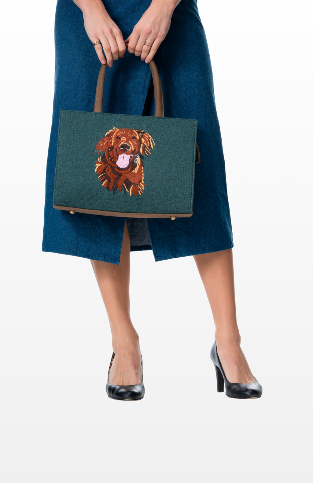 Woman holding a Fur-Ever Mine (Teal) tote bag by the brand Story of Strings.