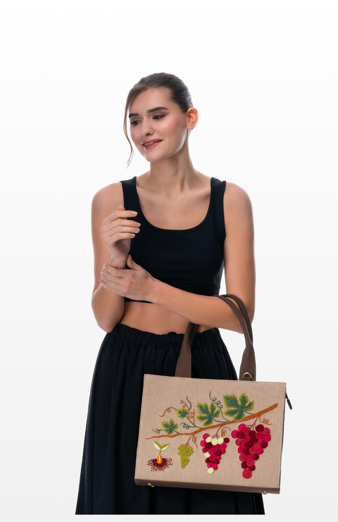 A woman wearing Heirloom Vines handbag by the brand Story of Strings.