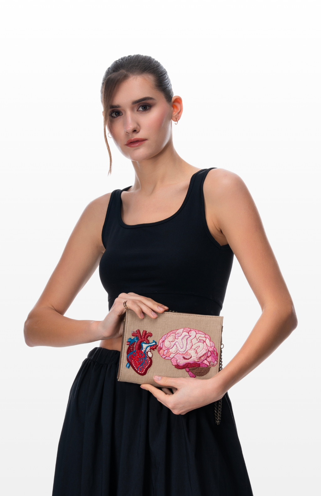 woman holding Love & Logic sling purse by the brand Story of Strings.