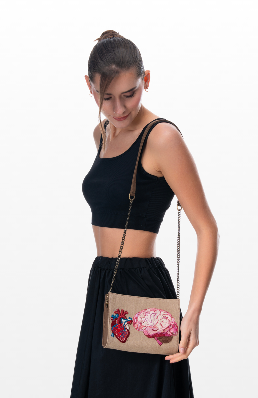 Woman wearing Love & Logic sling purse by the brand Story of Strings.