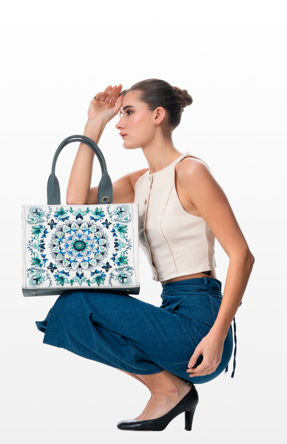 Woman holding Mandala Magic tote bag by the brand Story of Strings.