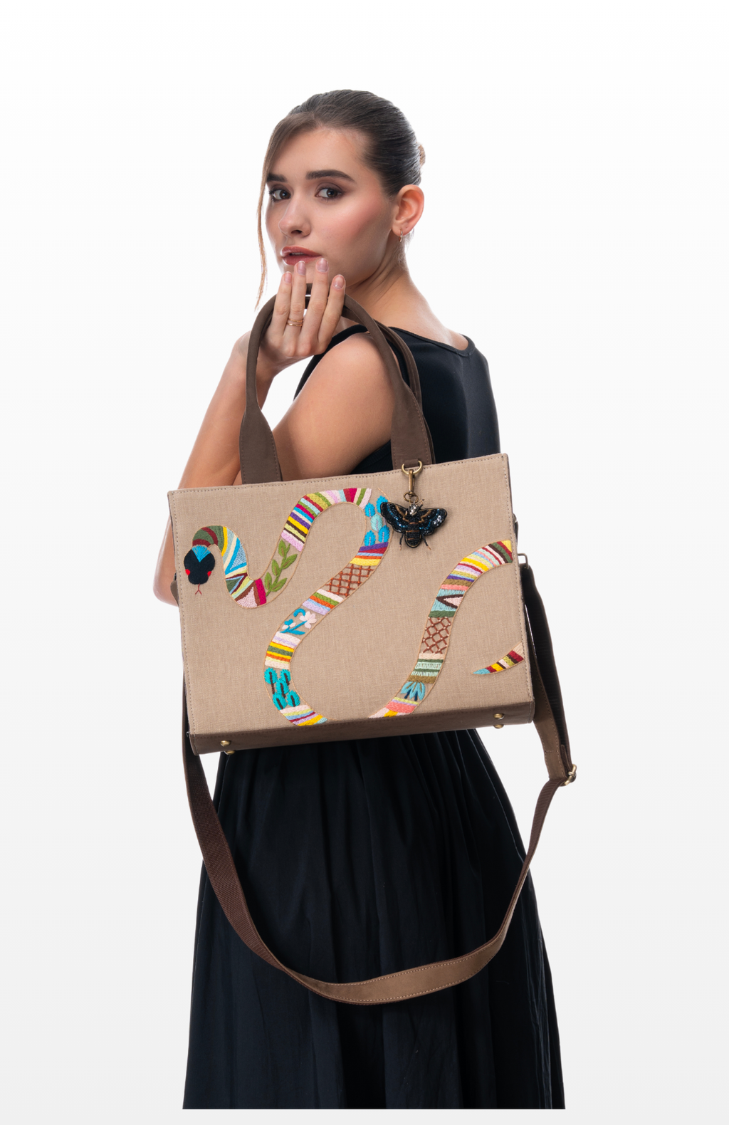 Woman holding the Mosaic Snake Print by the brand Story of Strings.