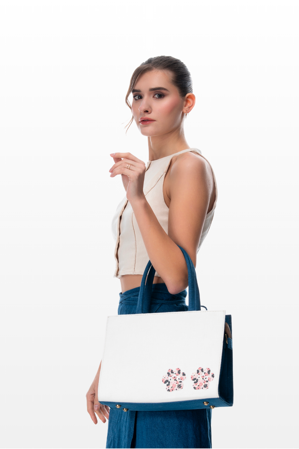 Woman wearing a Paws and Posies handbag by the brand Story of Strings
