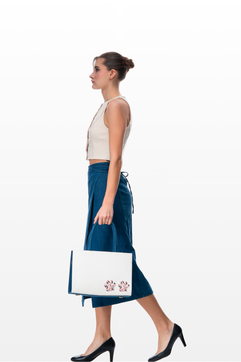 Woman carrying a Paws and Poises handbag by the brand Story of Strings 