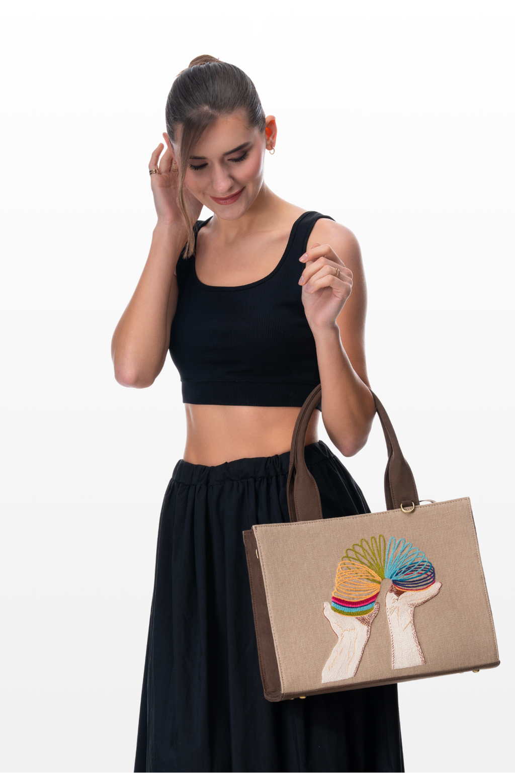 Woman wearing a Retro Springs handbag by the brand Story of Strings 