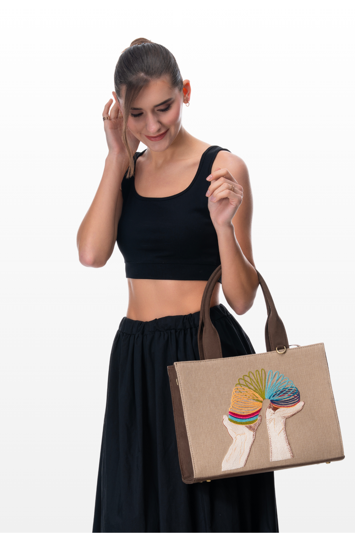 Woman wearing a Retro Springs handbag by the brand Story of Strings 