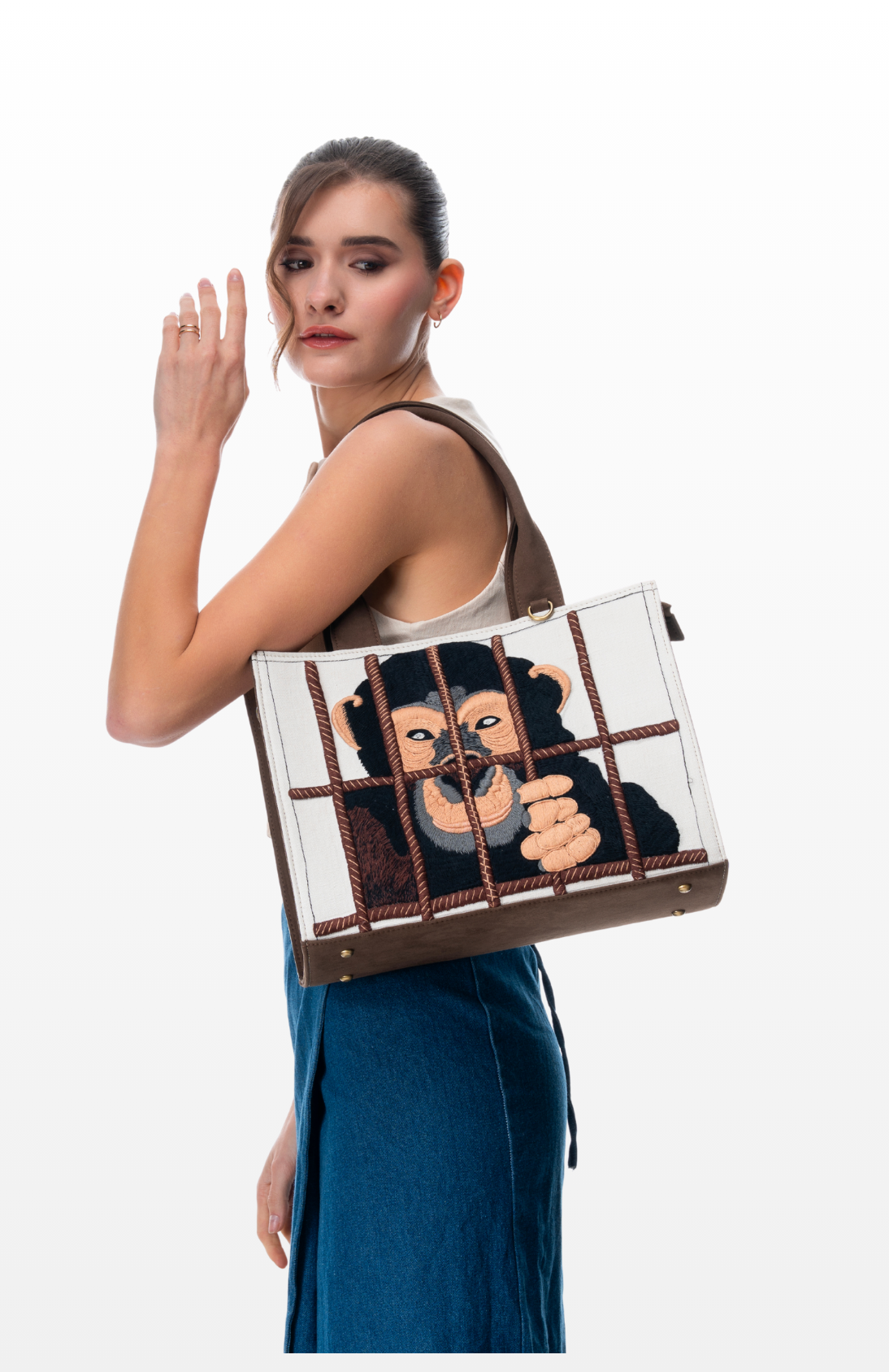 Woman wearing Save the Chimps handbag by the brand Story of Strings.