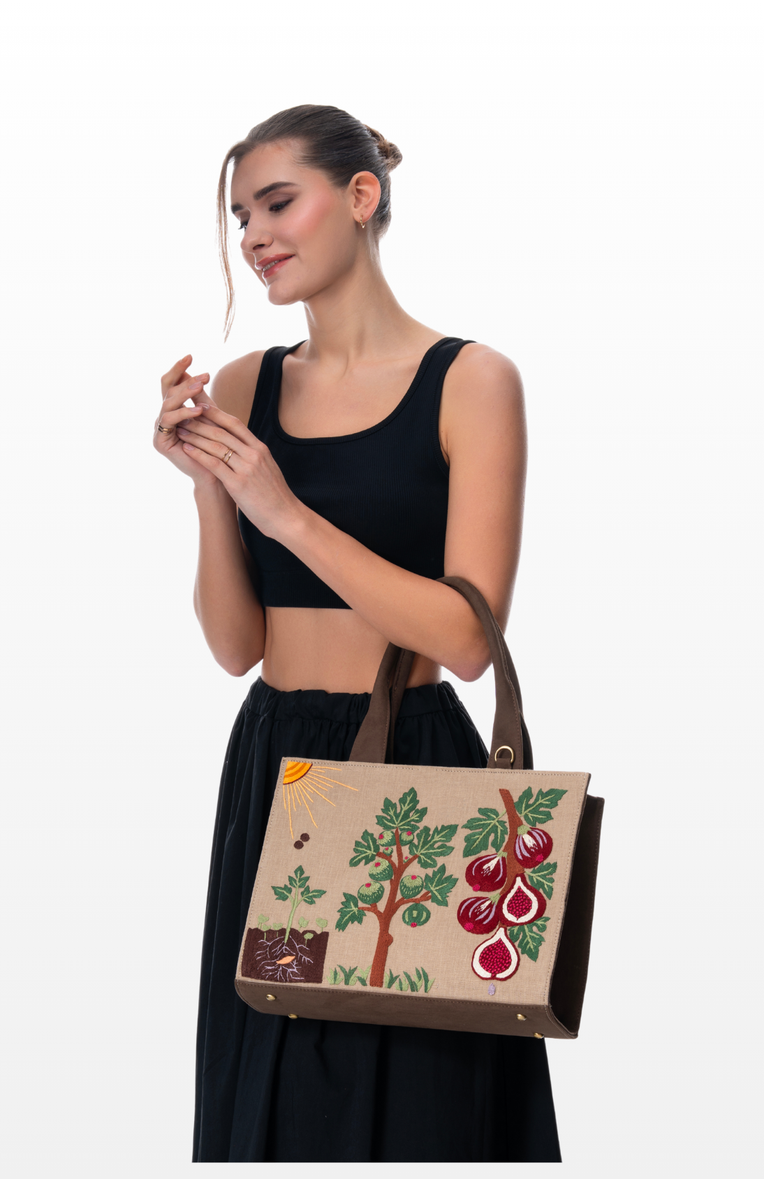 Woman holding Seasons of Figs handbag by the brand Story of Strings.