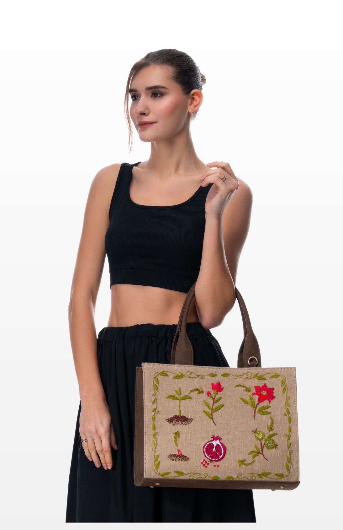 Woman wearing Seed to Jewel handbag by the brand Story of Strings.