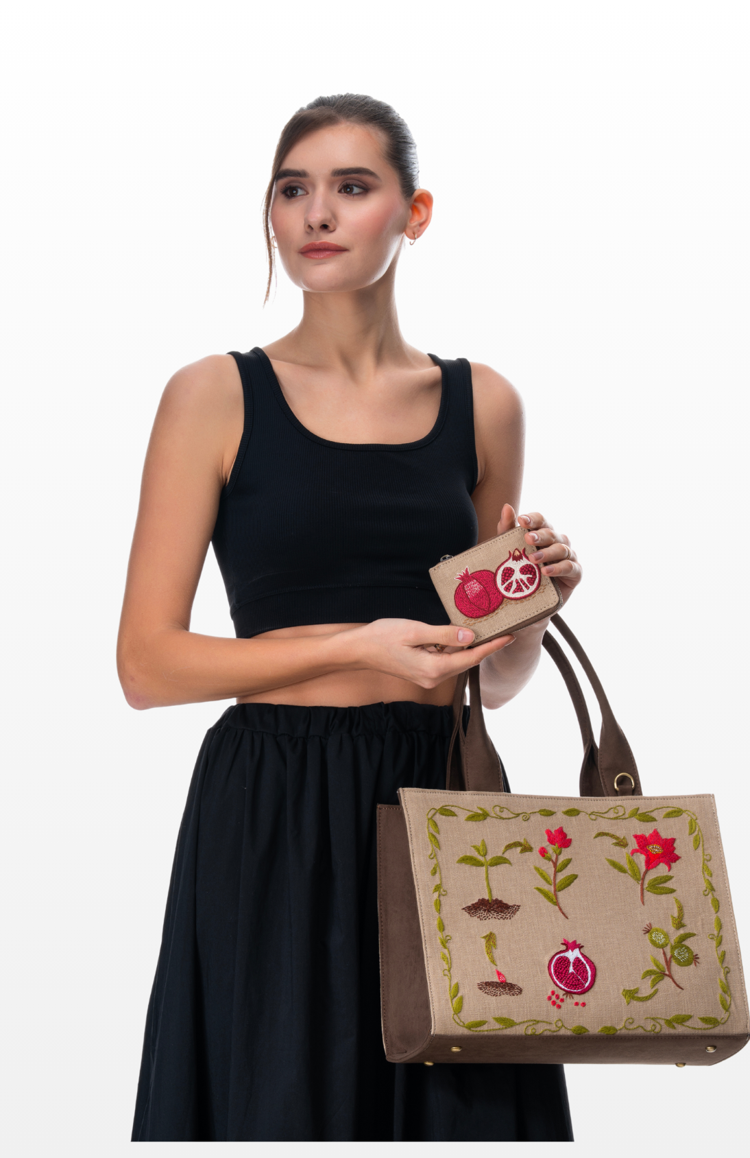 Woman wearing a Seed to Jewel handbag and wallet by the brand Story of Strings. 