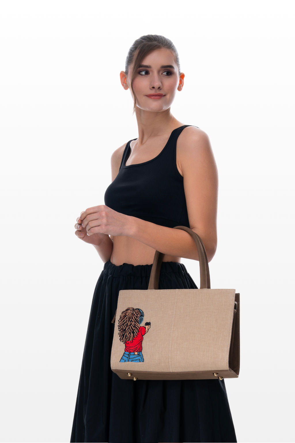 Woman Wearing a Steady Aim handbag by the brand Story of Strings 
