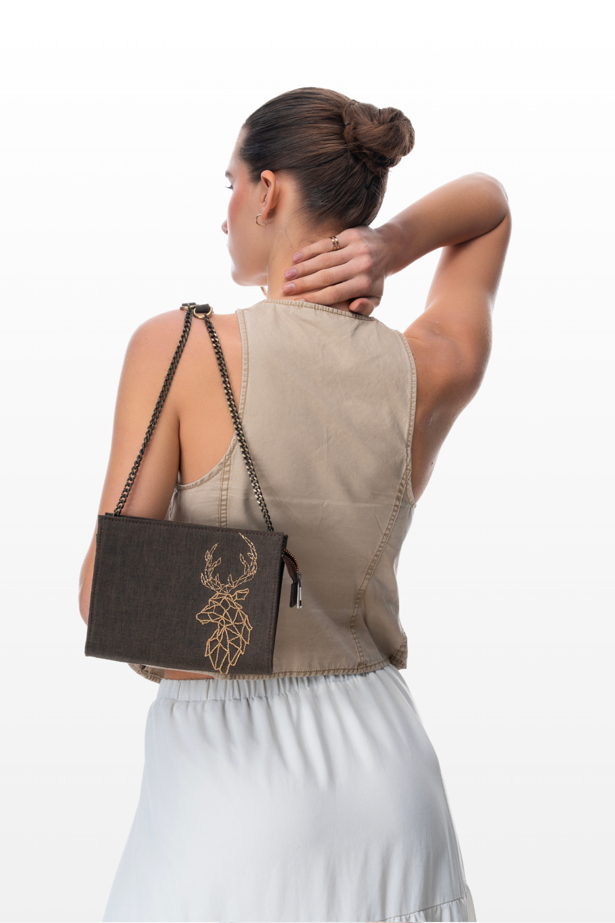 Woman wearing a Sling Purse Still Wild by the brand Story of Strings