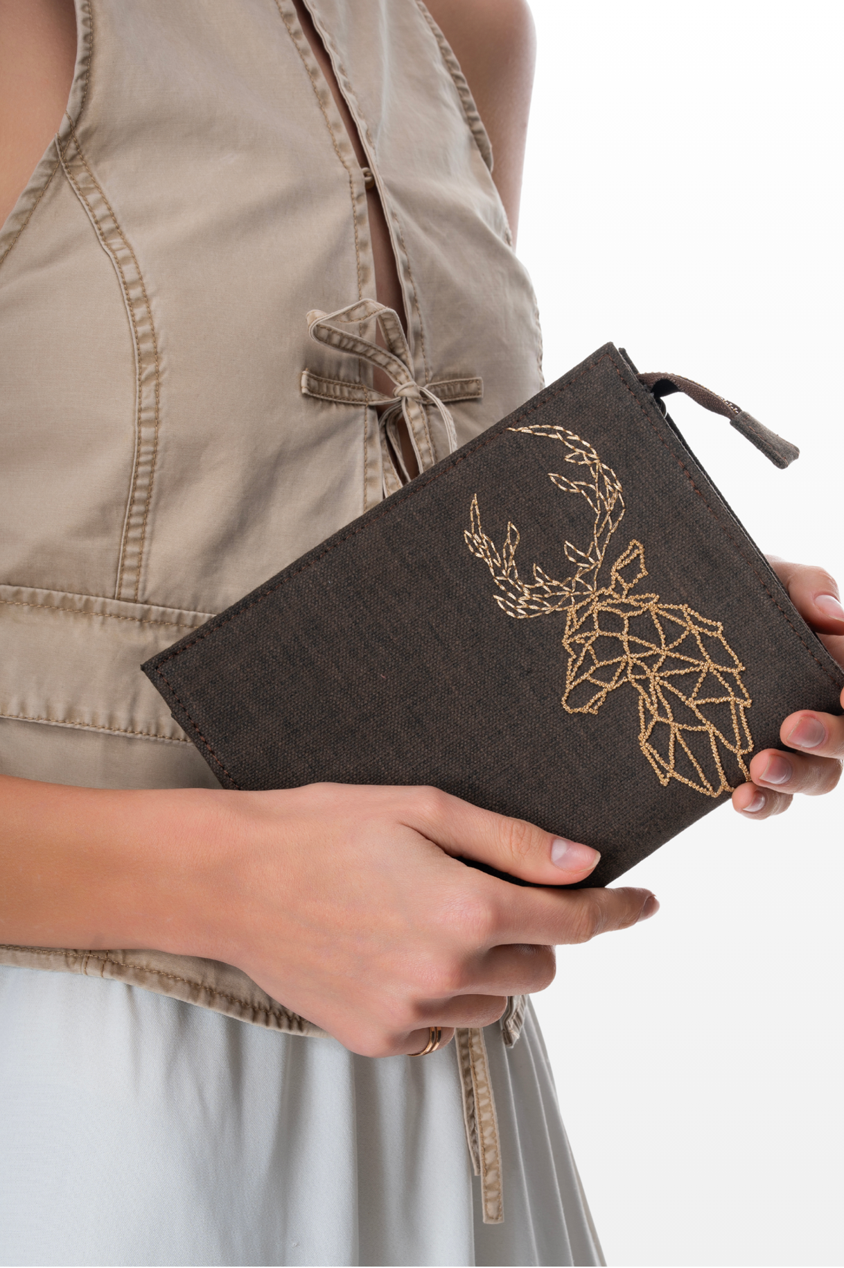 Woman Holding a Sling Purse Still Wild by the brand Story of Strings 