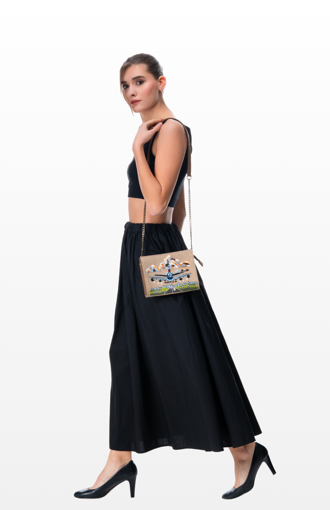 Woman weaing Take-off sling purse by the brand Story of Strings.