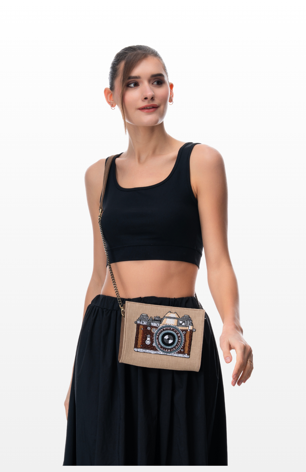Woman wearing The Vintage Lens sling purse by the brand Story of Strings.