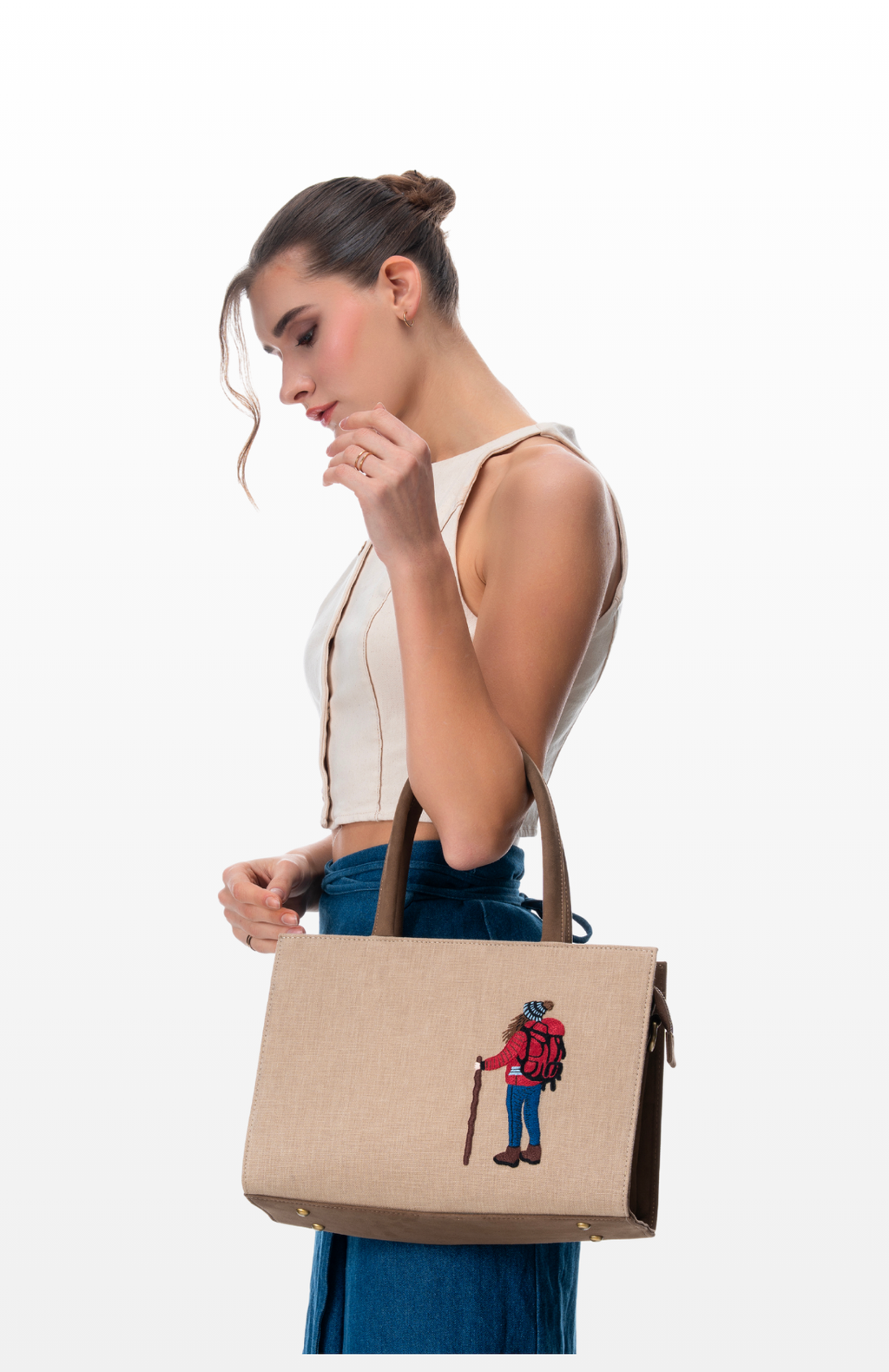 A woman carrying The Wanderer tote bag by the brand Story of Strings.