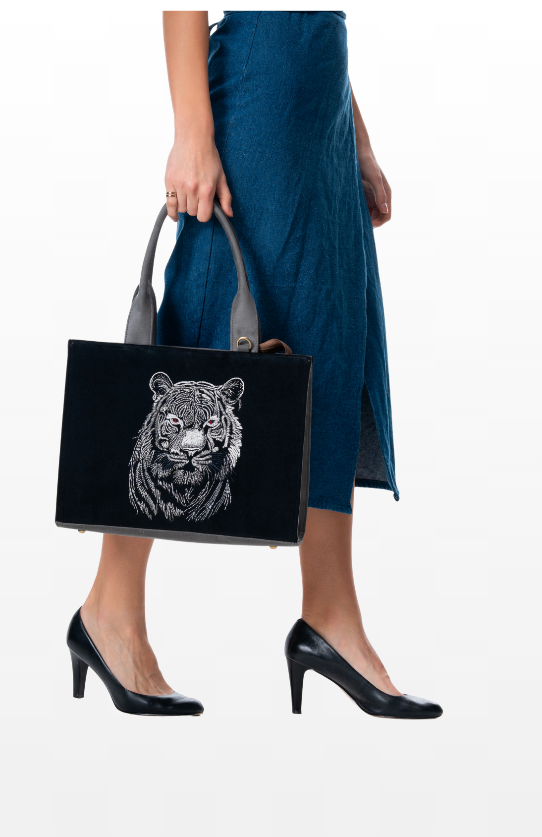 Woman holding Tiger's Pride tote bag by the brand Story of Strings.