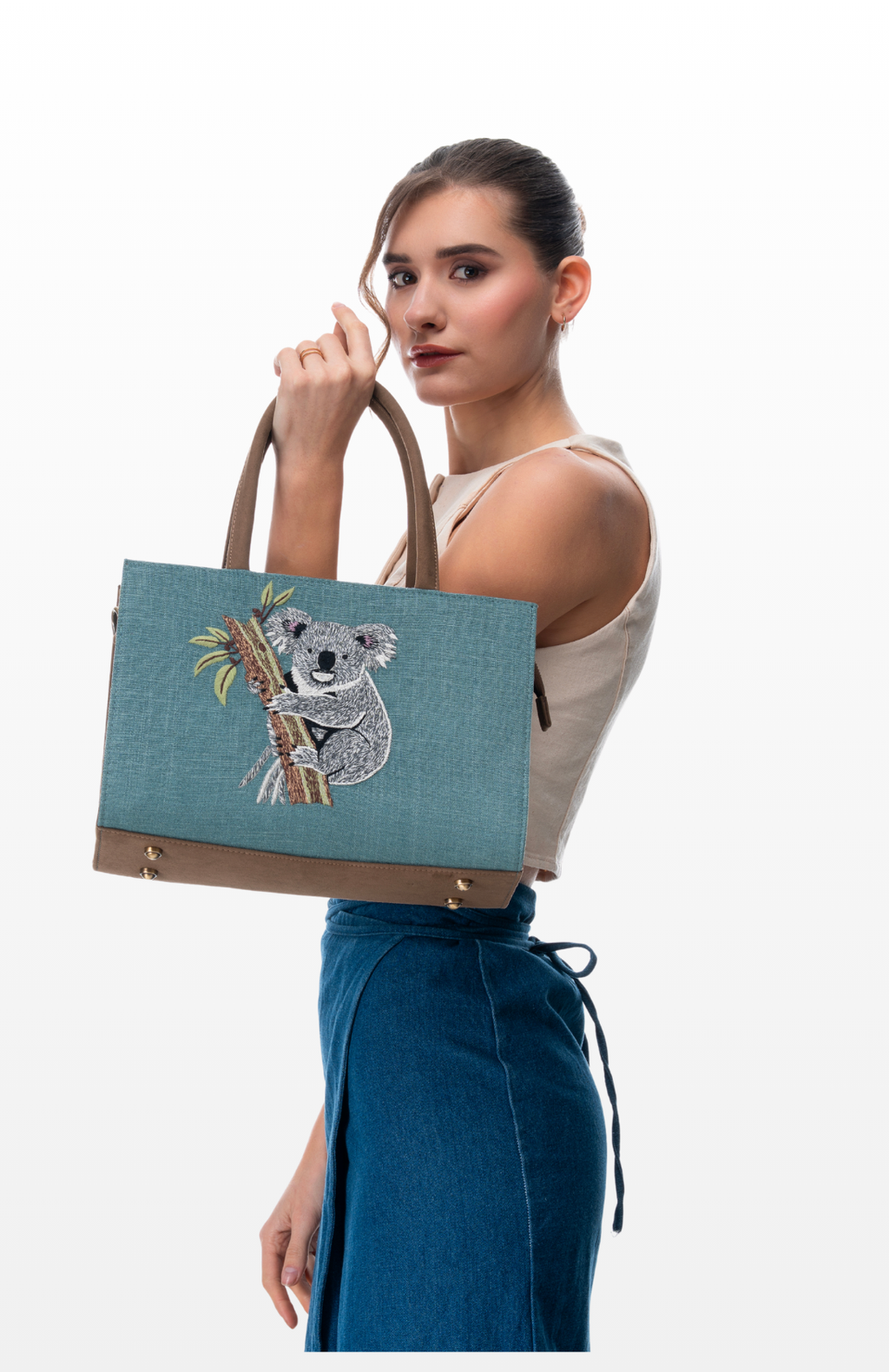 Woman carrying medium tote bag Tree Hugger by the brand Story of Strings.